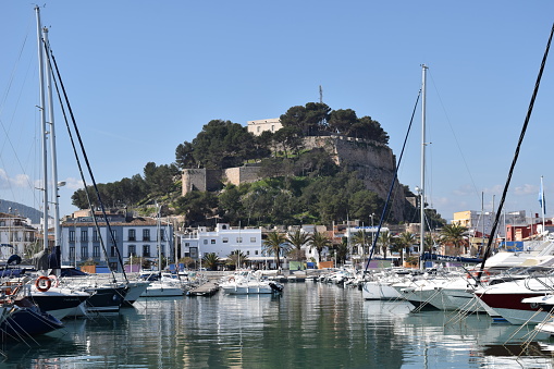 The harbor front showing the marina and castle in Denia, Spain
