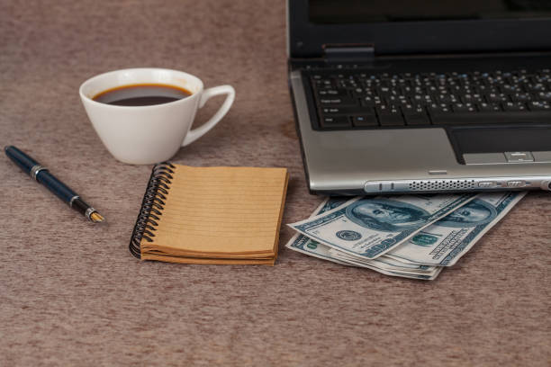 istock book note and laptop with money on table 692162462