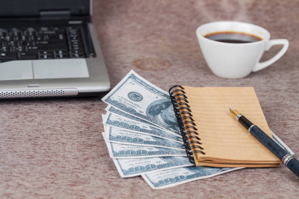istock book note and laptop with money on table 692162468