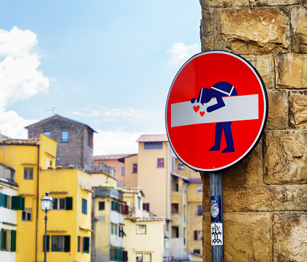 Florence: Street art at historic center of Florence, Tuscany. Traffic sign turned into humorous art by French Artist Clet Abraham. It is a popular attraction of Florence.