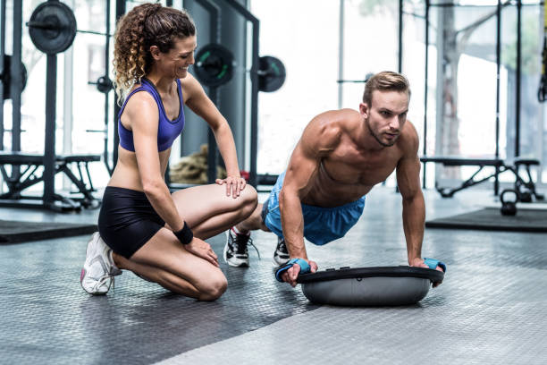 istock Muscular couple doing bosu ball exercises 692165636
