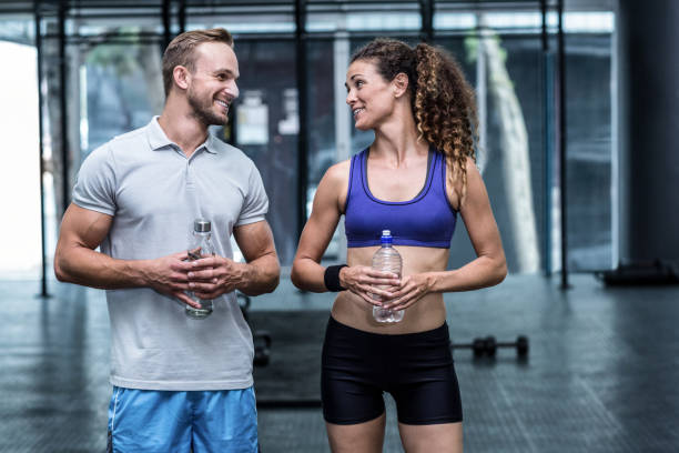 istock Muscular woman discussing with trainer 692169538