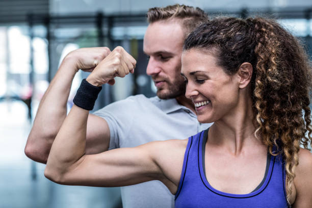 istock A muscular couple flexing biceps 692169644