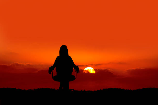 istock silhouetted woman watching sunset 692171906