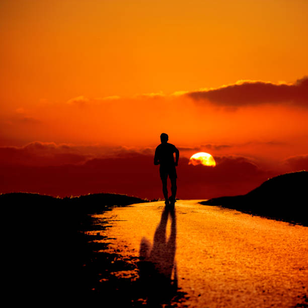 istock silhouetted man walking outdoor at dusk 692172314
