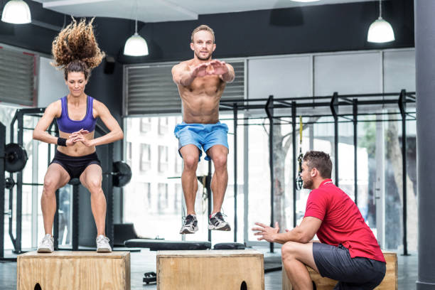 istock Two muscular athletes doing jumping squats 692172784