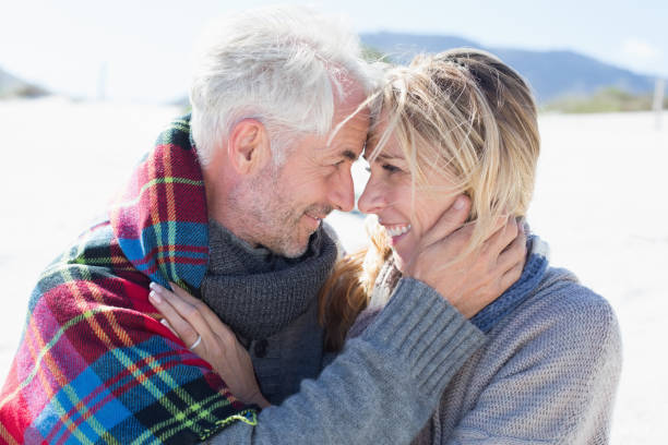 istock Happy married couple embracing on the beach 692173110