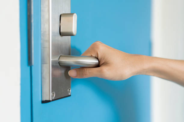 istock hand hold handle of door, close up 692173260