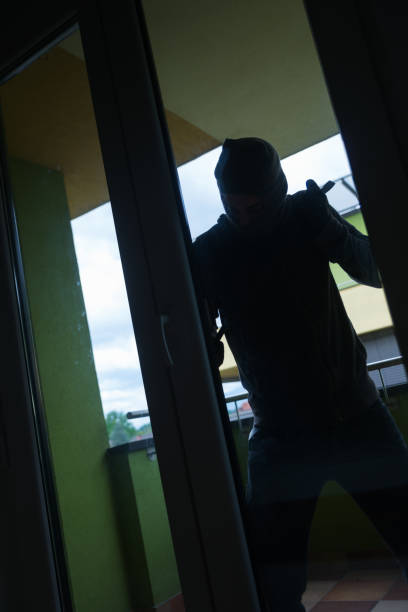istock Burglar breaking into a house 692173318