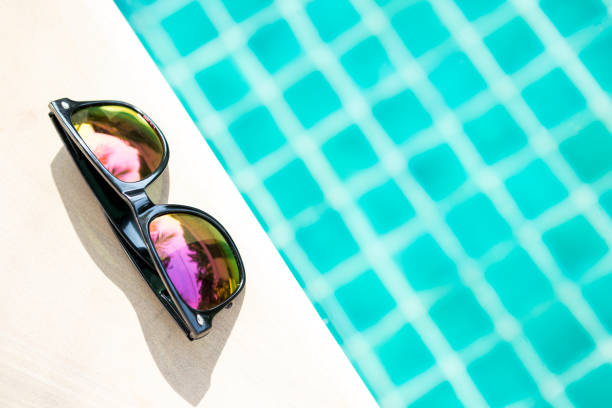 istock Design sunglasses on swimming pool edge 692178386