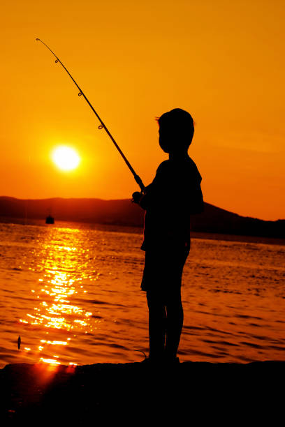 istock little boy fishing 692178460