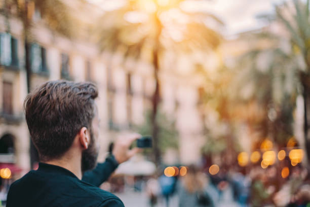 istock Young man taking photos in Barcelona, Spain 692178534