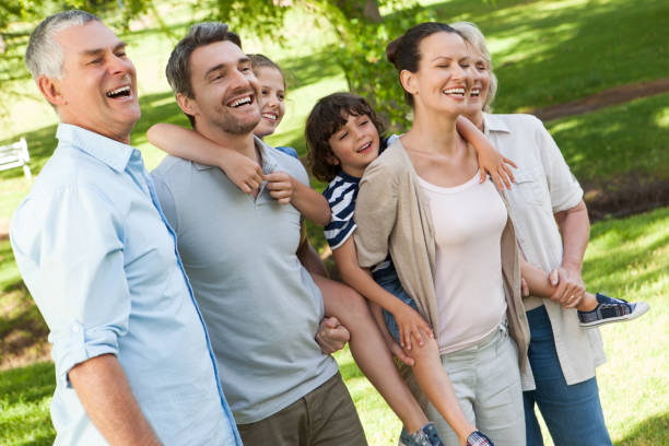 istock Cheerful extended family standing at park 692179714