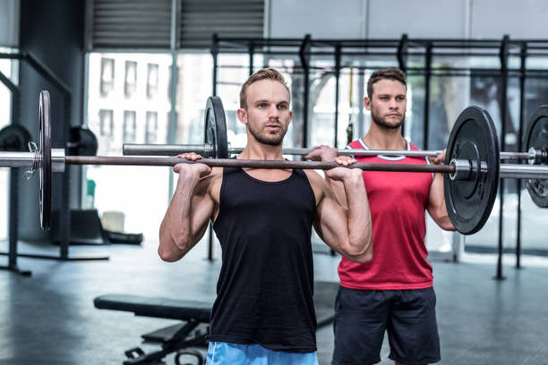istock Muscular men lifting a barbell 692182476