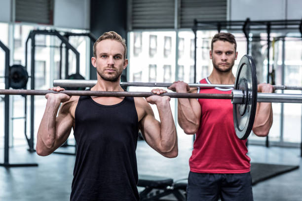 istock Muscular men lifting a barbell 692182576