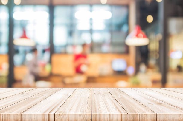istock Empty wooden table top with blurred restaurant interior background. can be used product display. 692188292