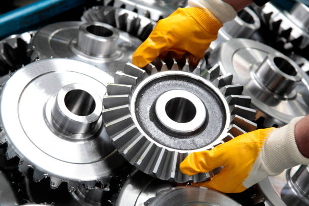 gear wheel and worker - engineering industry gear machine part imagens e fotografias de stock