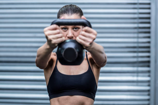 istock A muscular woman lifting kettlebells 692188654