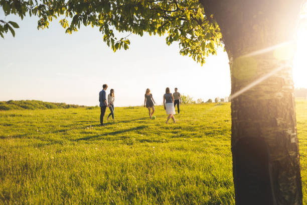 istock friends playing with ball on grassy field 692199984