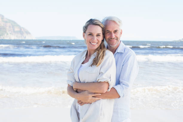 istock Happy couple hugging on the beach woman looking at camera 692200632