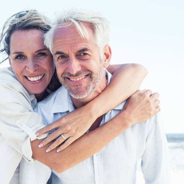 istock Attractive married couple posing at the beach 692200928