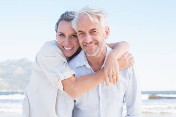 istock Attractive married couple posing at the beach 692200960