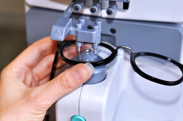 Female optician measuring and preparing glasses