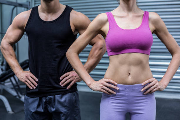 istock Muscular couple with hands on the hips 692208194
