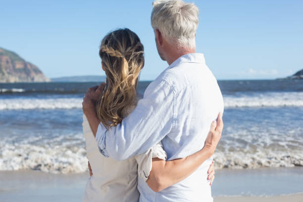 istock Couple on the beach looking out to sea 692208284