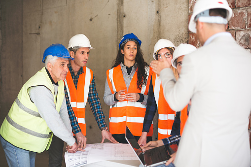 Workers talking at construction site