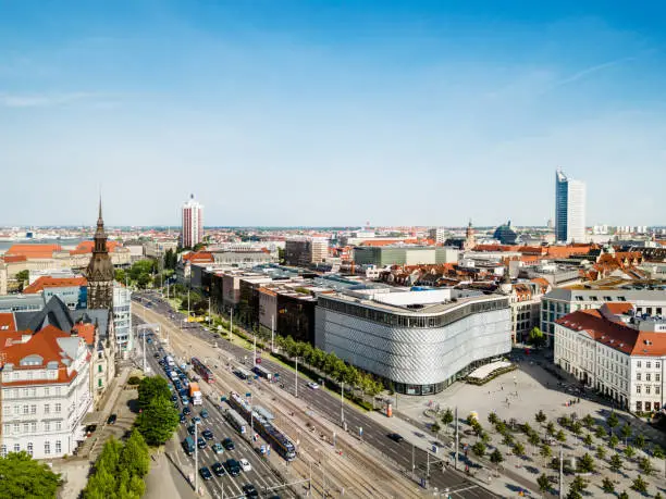 Aerial view from a drone over the so called Brühl with lots of shopping centers and stores in Leipzig, Germany. University tower (Uniriese in german) is seen in the background.