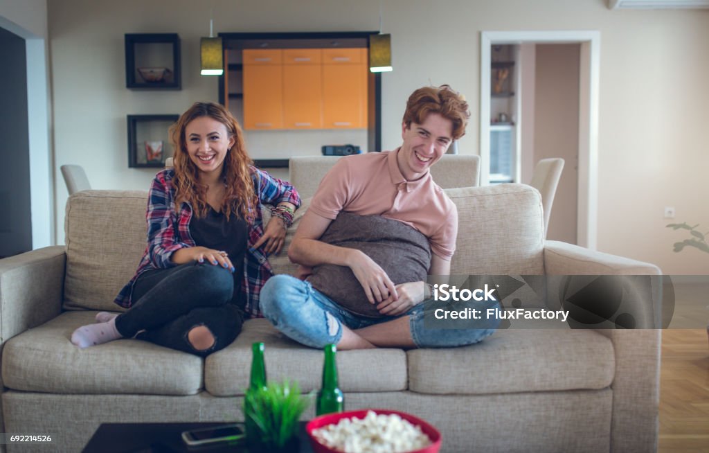 Laughing At A Funny Scene In An Old Movie Stock Photo - Download Image Now  - Sofa, Humor, Watching TV - iStock