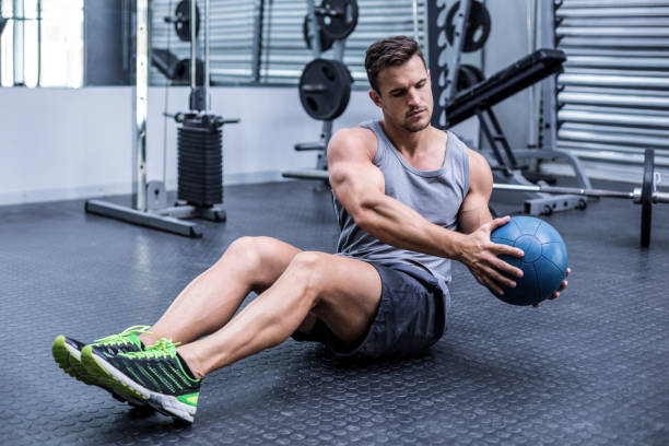istock Muscular man doing russian twist exercises 692215032