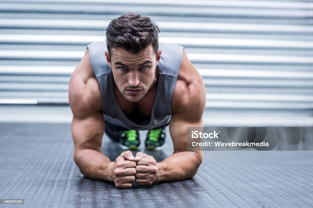 A muscular man on plank position Portrait of a muscular man on plank position 30-34 Years Stock Photo