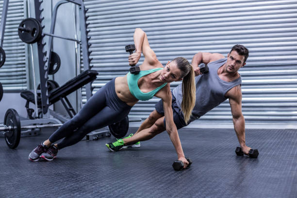 istock Smiling muscular couple doing side plank 692217782