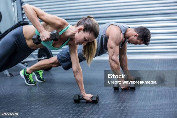 Muscular Couple Doing Plank Exercise Together Stock Photo - Download Image Now - 30-34 Years, 30-39 Years, Active Lifestyle