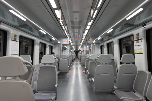 the inside of a renfe train wagon, empty at night.