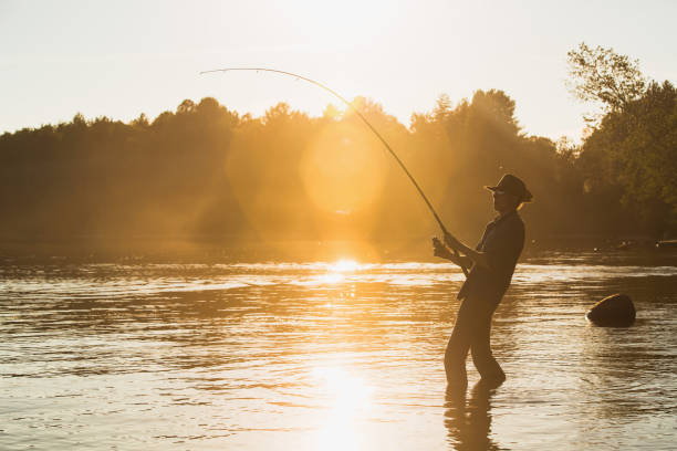 istock Fisherman at lake on sunset 692220682