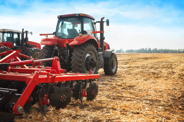 istock Red tractor in the field on a bright sunny day. 692220820