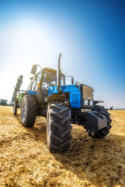 istock Modern tractor in the field on a sunny autumn day. 692220824