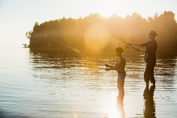 pêcheur et fils - finland family fishing summer photos et images de collection
