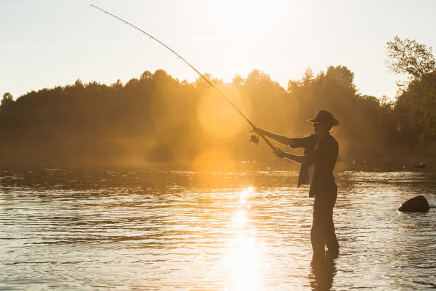istock Fisherman at lake on sunset 692221110