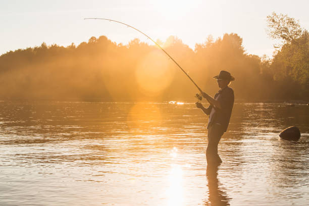 istock Fisherman at lake on sunset 692221156