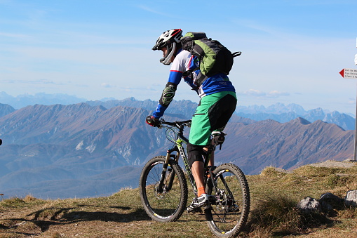 Mountain Biker cycling on the top of the hill,  downhill, Matajur, Slovenia, November 2014