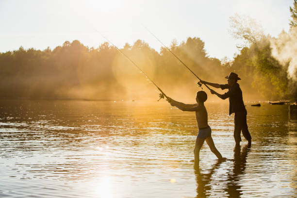 pêcheur et fils - finland family fishing summer photos et images de collection