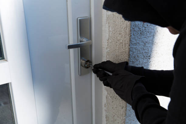 istock Burglar using special tools to break in a house 692224564