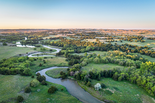 aerial view of Dismal River in Nebraska Sand Hills near Thedford, spring scenery lit by sunrise light