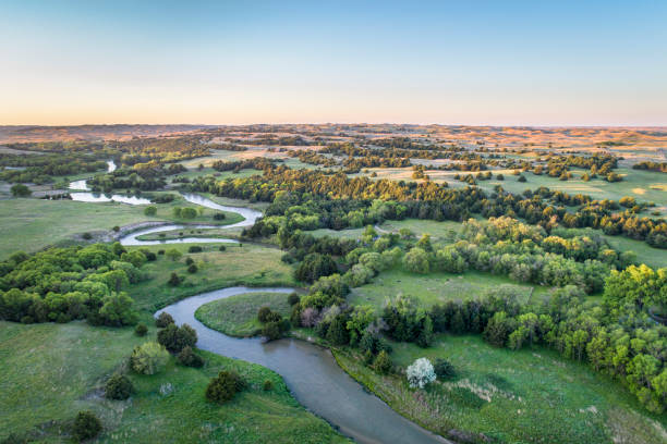 aerial view of Dismal River in Nebraska aerial view of Dismal River in Nebraska Sand Hills near Thedford, spring scenery lit by sunrise light nebraska stock pictures, royalty-free photos & images