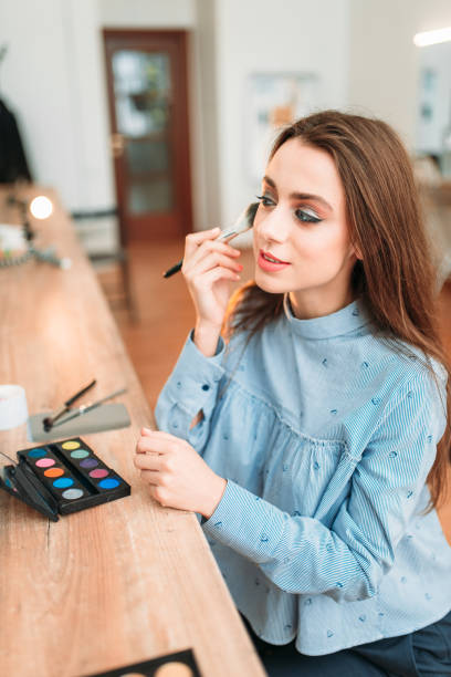 istock Woman sitting against mirror in beauty studio 692224874