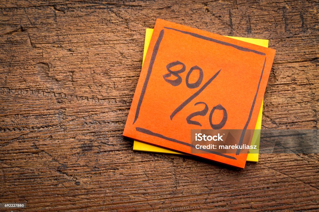 Pareto principle on sticky note Pareto principle or eighty-twenty rule represented on a sticky note against rustic wood - a reminder or advice Pareto Principle Stock Photo